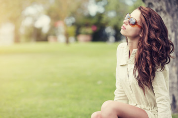 Smiling summer girl with sunglasses in italian garden