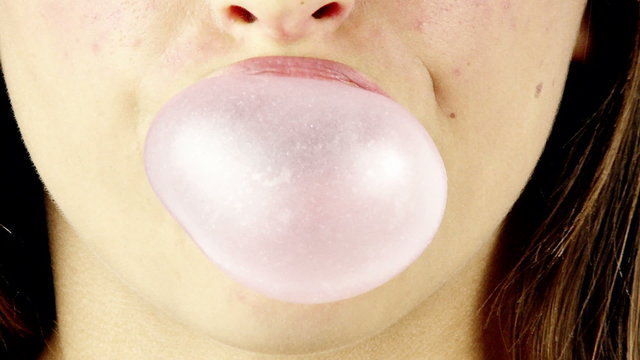 mouth doing bubble with chewingum close up