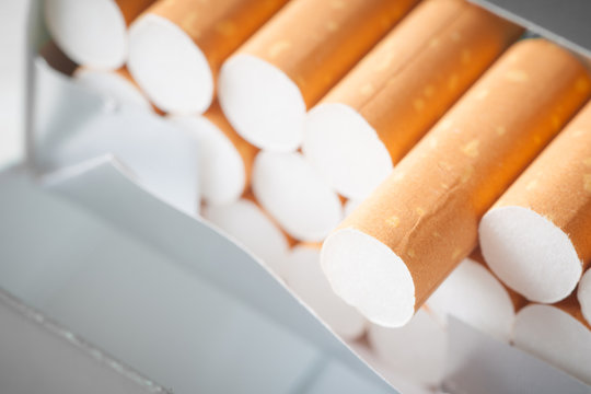 Close - up Pile of cigarette on white table background