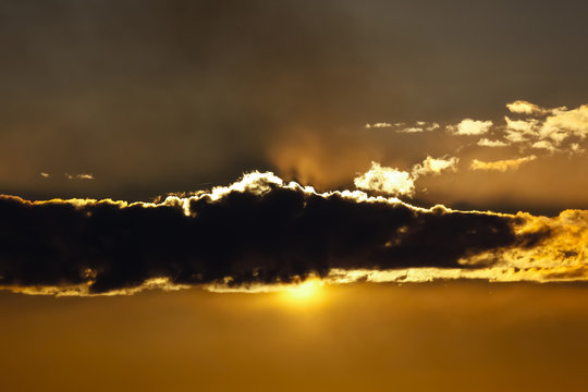 Sun hiding behind cloud