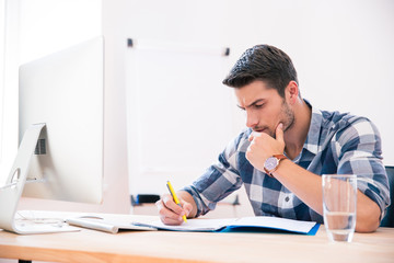 Businessman in casual cloth signing documents