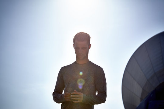 Germany, Raisting, young jogger at backlight