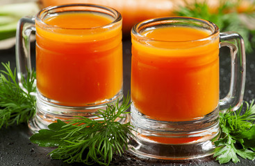 Fresh carrot diet  juice  in old-fashioned glass mug, selective