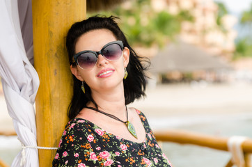 Young attractive Caucasian  woman enjoys sun on ocean resort 