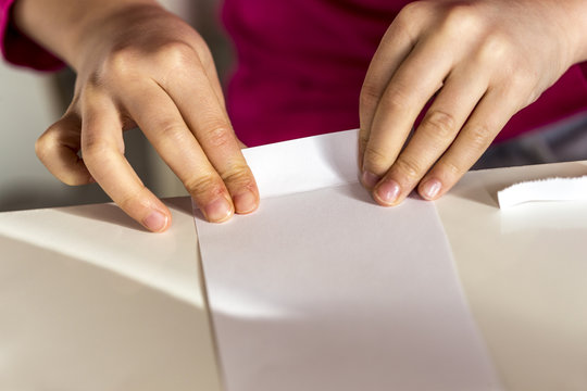 Girl folding piece of paper