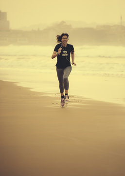 Spain, Gijon, Woman jogging at the beach