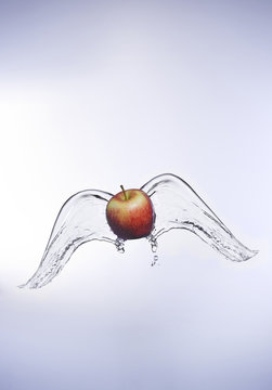 Red apple with angel wings of water