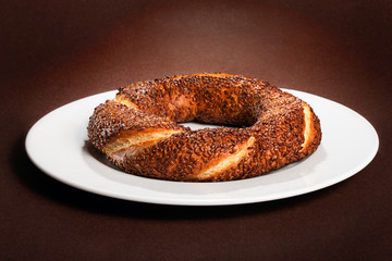 Simit (Turkish bagel) on white plate