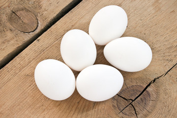 Chicken white eggs on wooden background