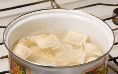 the dumplings cooks in a pan with the boiling water