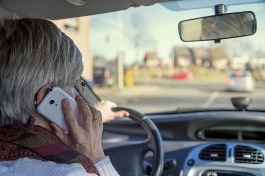 Senior woman in car on cell phone