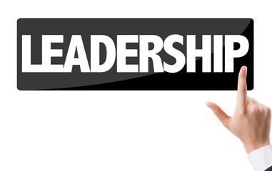 Businessman pressing button with the text: Leadership