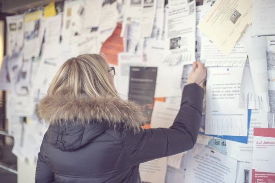 Woman reading at notice board