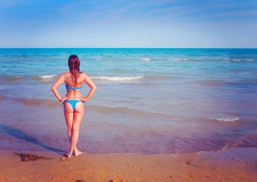 backside of a girl standing at the beach-summer 11