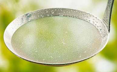 Close Up of Metal Strainer with Water Droplets