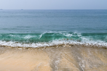 Sea waves on the sand beach