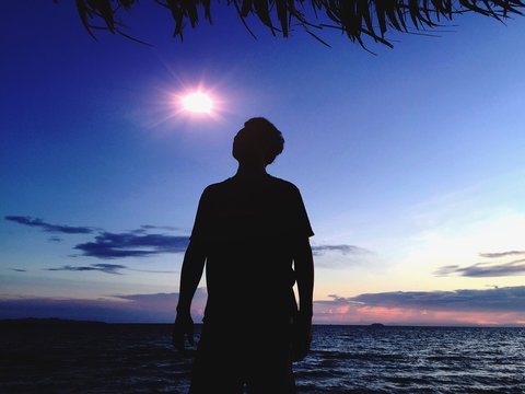 sun behide the man  