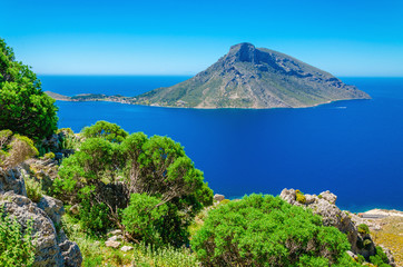 Greek volcano Island with green bushes, Greece