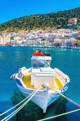 Colorful boat with yellow deck moored in Greek bay - 85334153