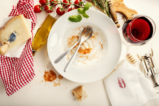 Spaghetti Bolognese, empty plate napkin with kissing lips