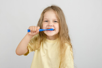 Four-year girl brushing her teeth