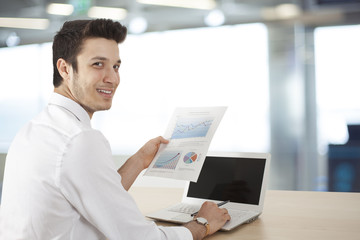 Businessman sitting table and holding document