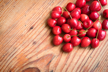 Ripe organic homegrown cherries on wooden background