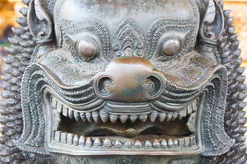 Face of bronze lion statue. Wat Pho Temple. Bangkok