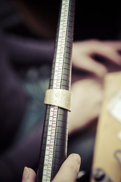 Goldsmith working on wedding rings, unfinished workpiece on ring mandrel