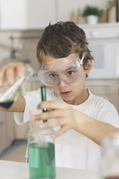 Boy playing science experiments at home