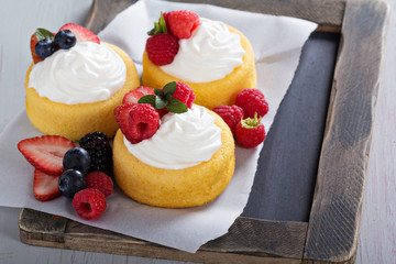 Pastry cups filled with cream and fresh berries