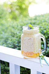 Peach and mango smoothie outdoor in the morning