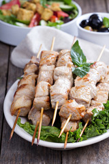 Pork kebabs with fresh salad leaves