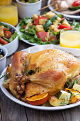 Whole roasted chicken on dinner table