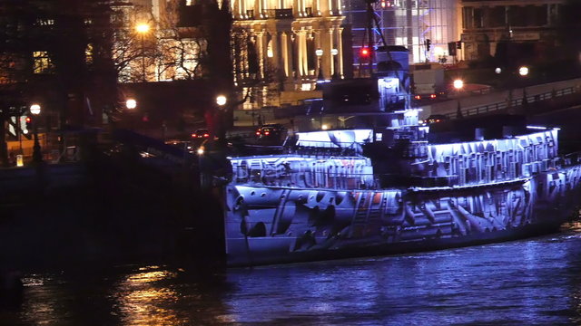 A big boat on the Thames river with passengers on board ready to explore at night
