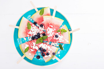 Fresh watermelon popsicles with blueberries