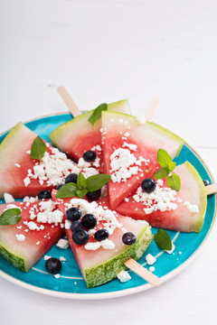 Fresh watermelon popsicles with blueberries