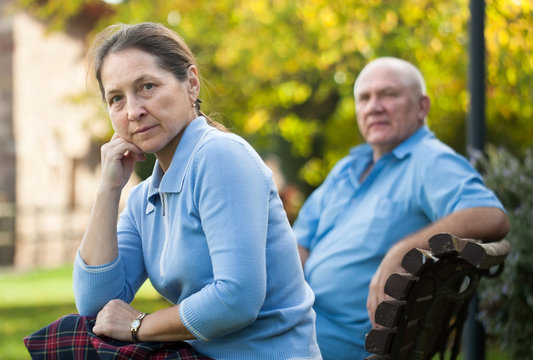 mature couple sitting on   bench