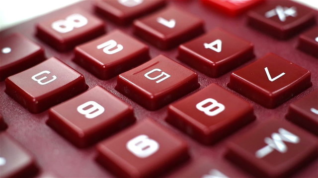 woman finger pushing calculator buttons, extra close up