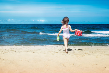 Little Girl running on the beach