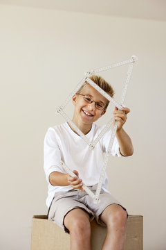 Boy with pocket rule formed like a house