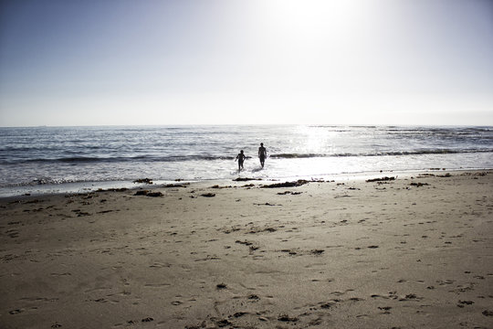 Namibia, Swakopmund, two boys playing at seafront