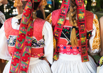 Anonymous girls in folklore costumes, back detail
