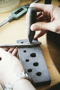 Goldsmith preparing with mandrel wedding ring work piece