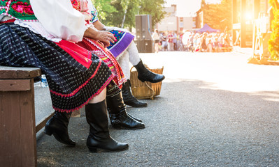 Anonymous senior female friends in folklore costumes