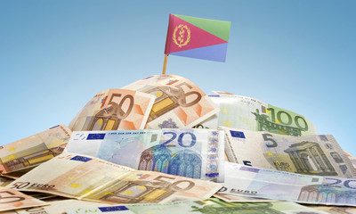 Flag of Eritrea sticking in a pile of various european banknotes