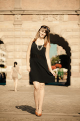 Flapper girl woman in1920s style standing on the street