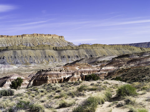 Bentonite Hills and Factory Butte near Hanksville, Utah, with the Henry Mountains in the background