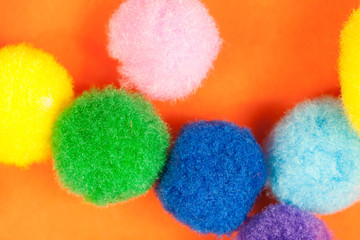 Vivid playful fluffy fuzzy textile light balls in different colors, arranged randomly, symbolizing pure happiness concept