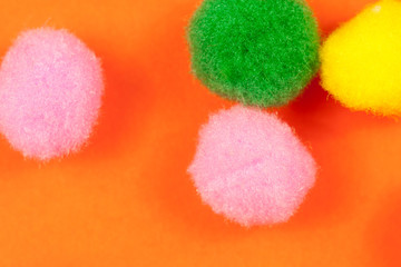Vivid playful fluffy fuzzy textile light balls in different colors, arranged randomly, symbolizing pure happiness concept